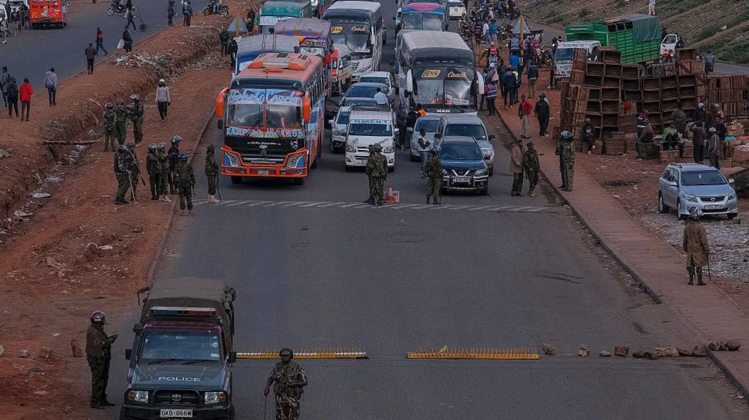Families lay flowers on barbed wire barricade on anniversary of deadly Kenya protests