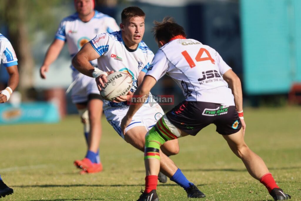 Wanderers go top after bruising battle